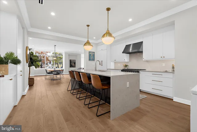 a kitchen with stainless steel appliances a stove a sink and a microwave