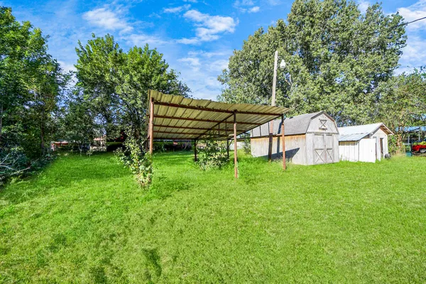 a view of a house with a backyard and a patio
