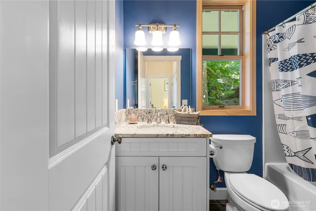 a bathroom with a toilet a sink and a mirror