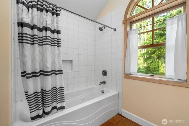 a bathroom with a bathtub and a shower