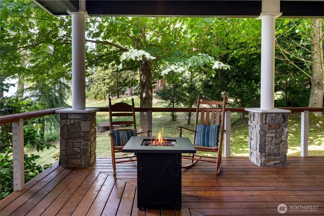 a view of a balcony with wooden floor and outdoor seating