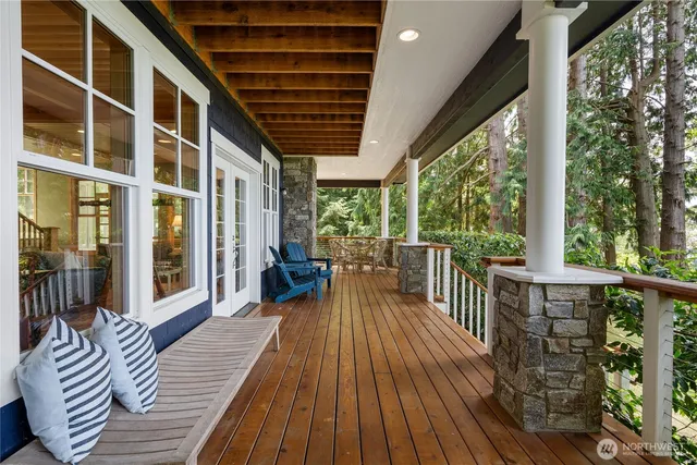 a view of balcony with chairs and wooden floor