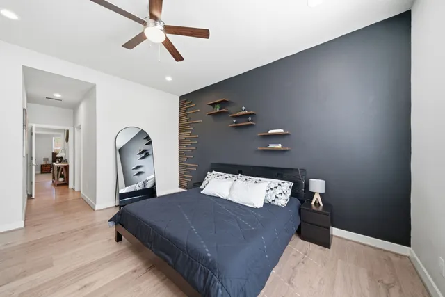 a bedroom with a bed and a chandelier
