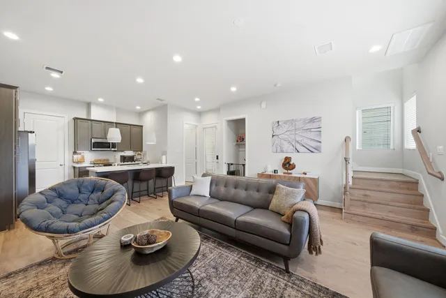 a living room with furniture and a dining table