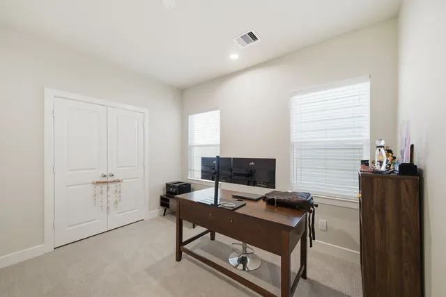 a view of a workspace with furniture