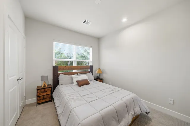 a bedroom with a bed and window