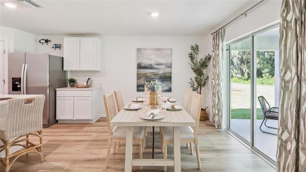 8982 Southwest 46 Terrace Ocala, FL 34476 - Photo 7 of 22 a view of a dining room with furniture window and wooden floor