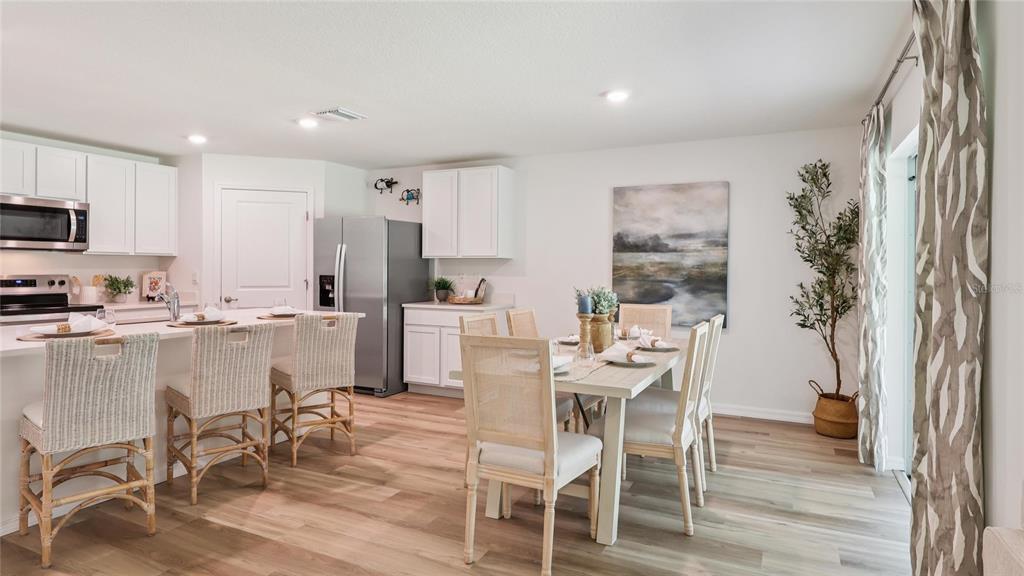 8982 Southwest 46 Terrace Ocala, FL 34476 - Photo 8 of 22 a kitchen with a table and chairs in it