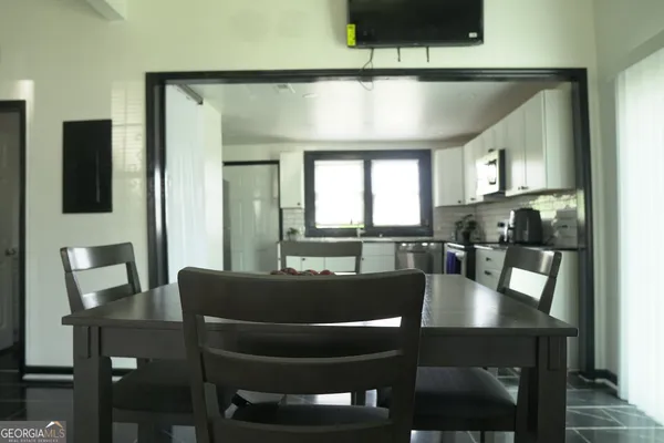 a view of a dining room with furniture and wooden floor