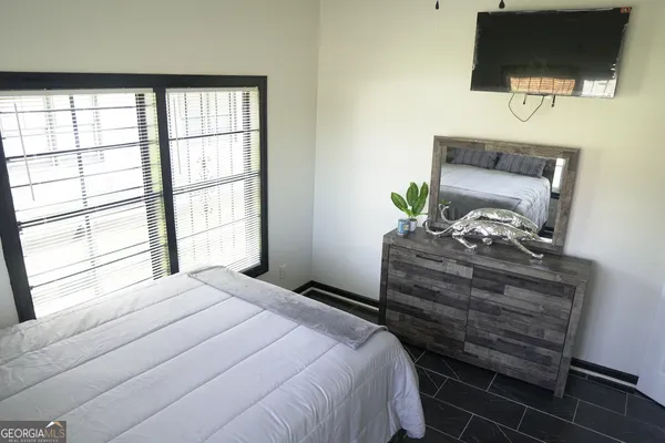 a bedroom with a bed and a window