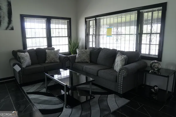 a bedroom with a bed table and window