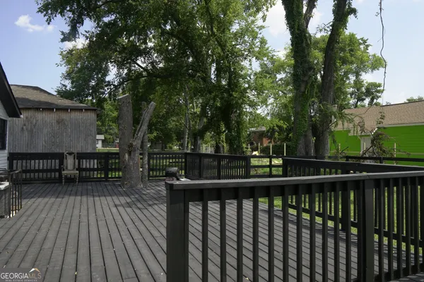 a view of deck with seating space and trees