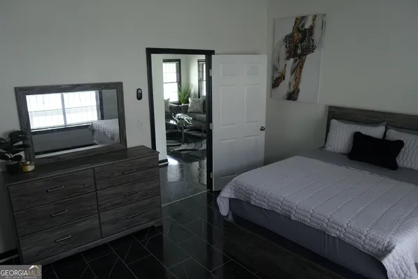 a bedroom with a bed and a dresser