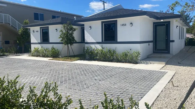 a front view of a house with garden
