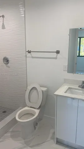 a bathroom with a vanity and a window