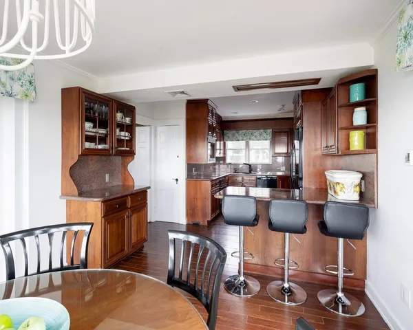 a dining room with furniture and wooden floor