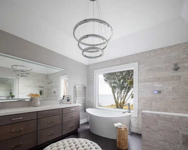 a bathroom with a granite countertop bathtub sink vanity mirror and toilet