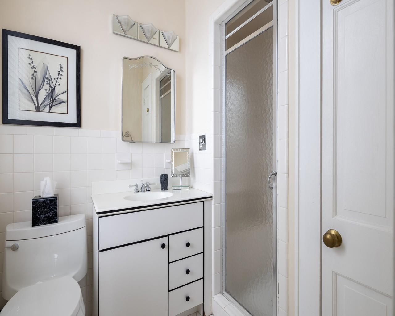 16 Point Road Bellport, NY 11713 - Photo 28 of 34 a bathroom with a toilet sink vanity and mirror
