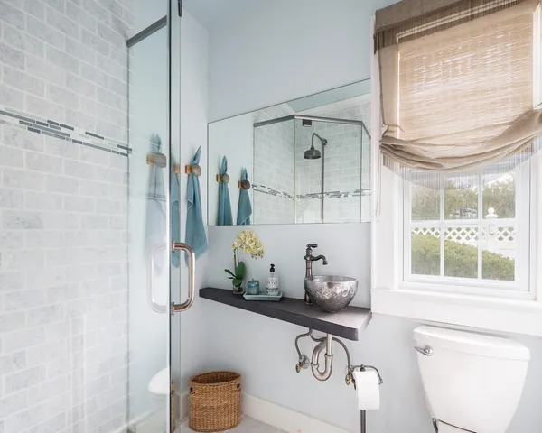 a bathroom with a granite countertop sink a toilet and shower