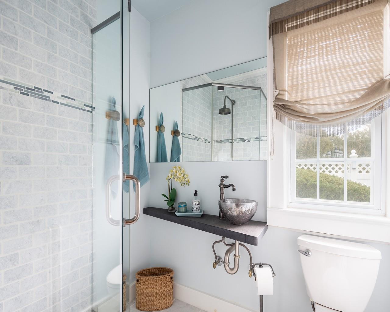 16 Point Road Bellport, NY 11713 - Photo 32 of 34 a bathroom with a granite countertop sink a toilet and shower