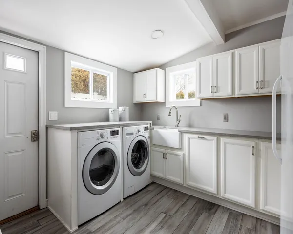 a utility room with sink dryer and washer