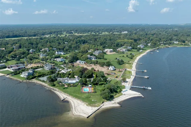 an aerial view of a house with a yard and lake view