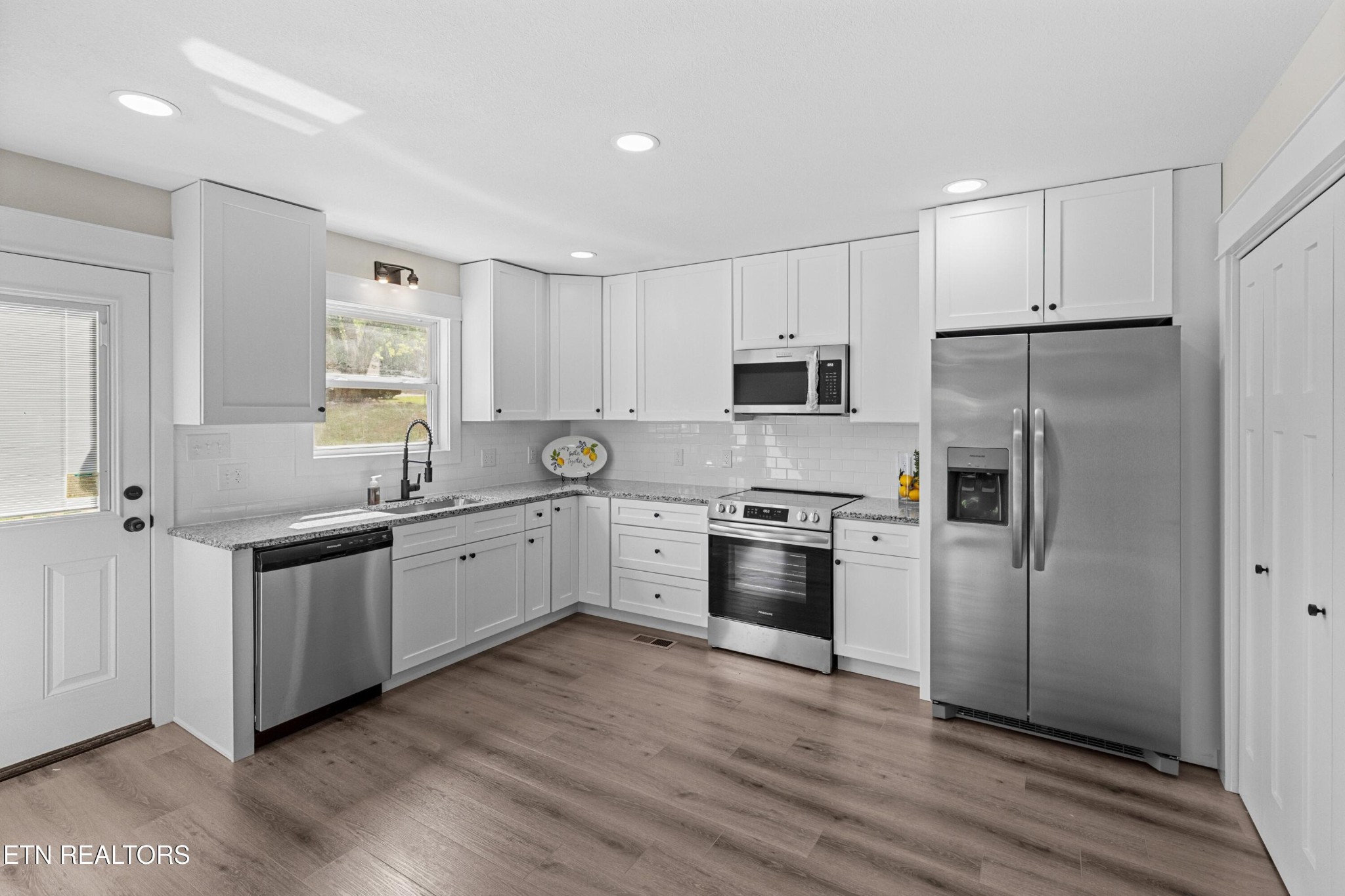 126 Double Cave Road Rutledge, TN 37861 - Photo 6 of 20 a large kitchen with cabinets wooden floor and stainless steel appliances