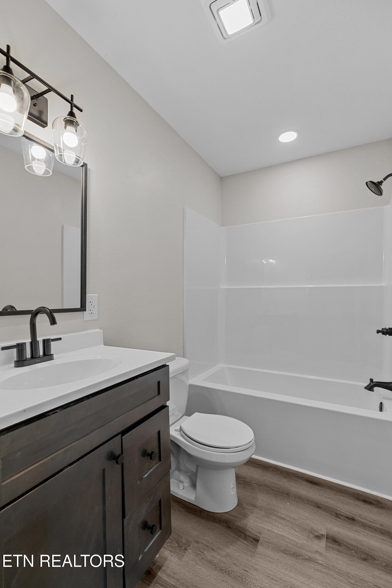 126 Double Cave Road Rutledge, TN 37861 - Photo 9 of 20 a bathroom with a sink a toilet a mirror and shower