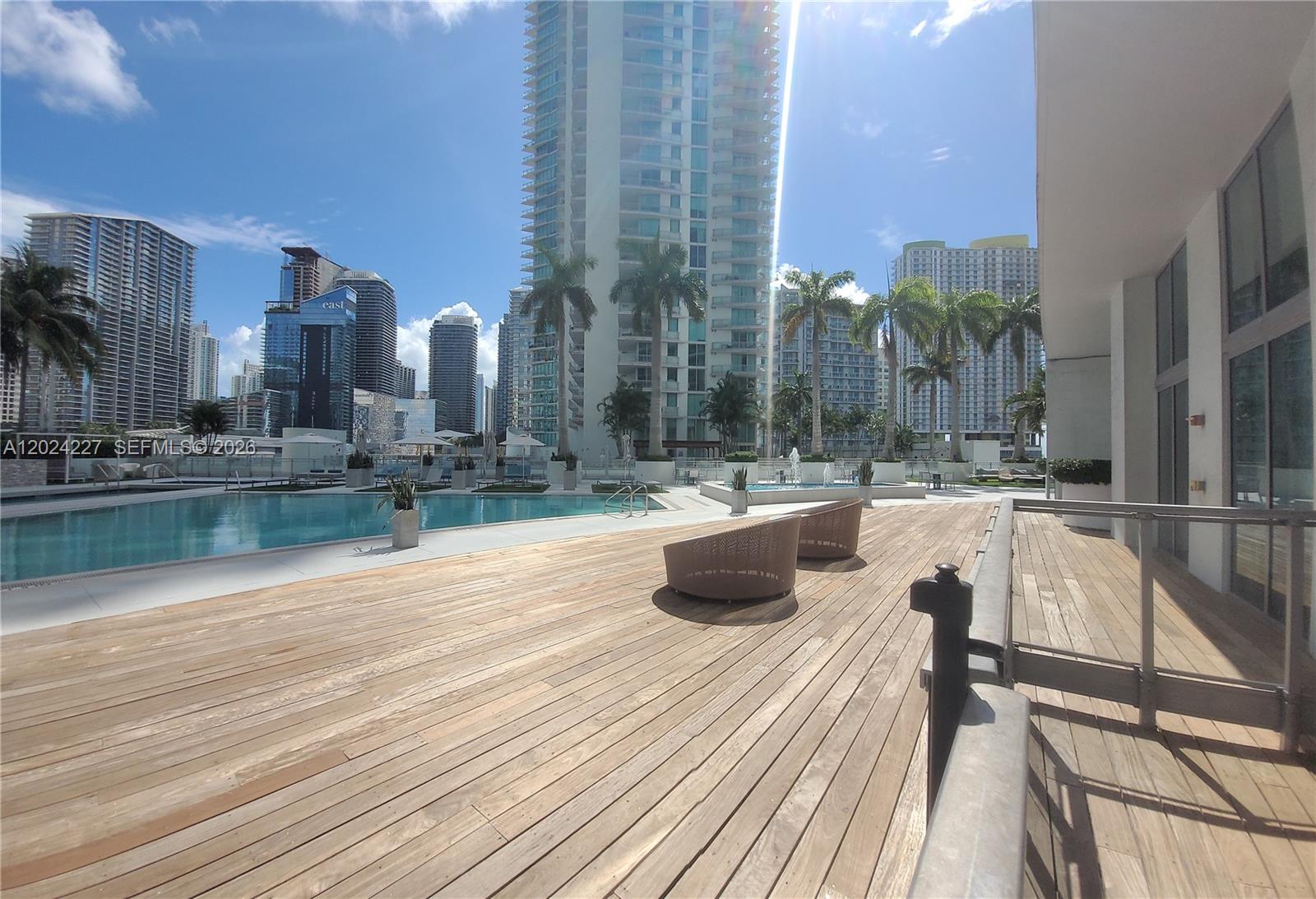 90 Southwest 3rd Street, Unit 2208 Miami, FL 33130 - Photo 49 of 56 a view of swimming pool with outdoor seating and city view