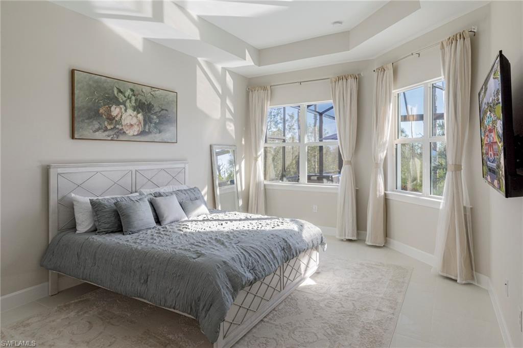 8982 Gustavia Court Naples, FL 34113 - Photo 11 of 44 a bedroom with a large bed and a window