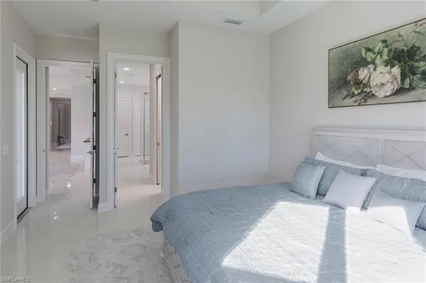 a view of a bedroom with wooden floor and bathroom