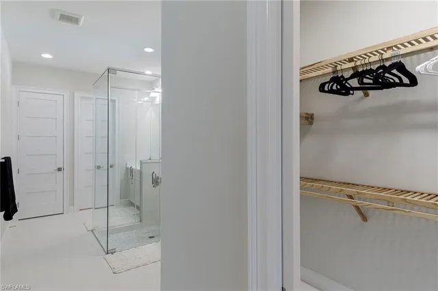 a bathroom with a shower and a glass door
