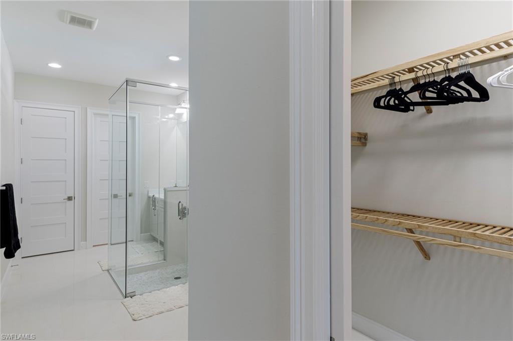 8982 Gustavia Court Naples, FL 34113 - Photo 13 of 44 a bathroom with a shower and a glass door
