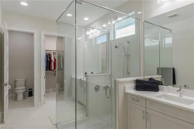 a bathroom with a double sink shower and a mirror