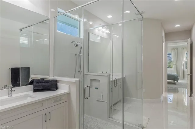 a bathroom with a shower sink and mirror