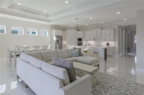 a living room with furniture and kitchen view