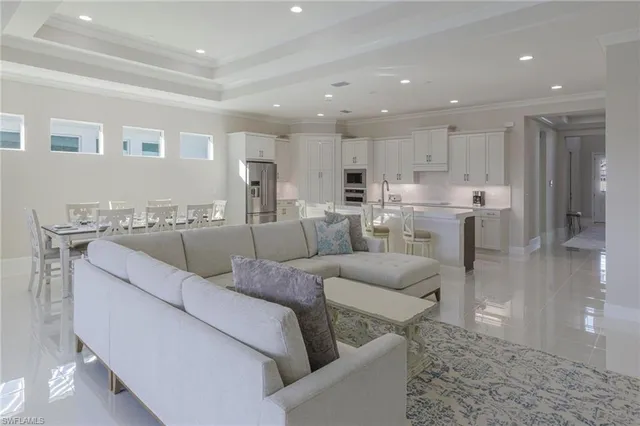 a living room with furniture and kitchen view