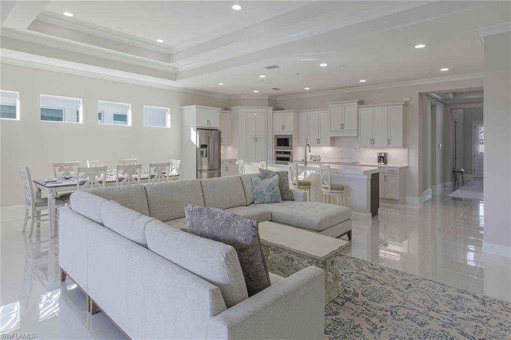 8982 Gustavia Court Naples, FL 34113 - Photo 16 of 44 a living room with furniture and kitchen view