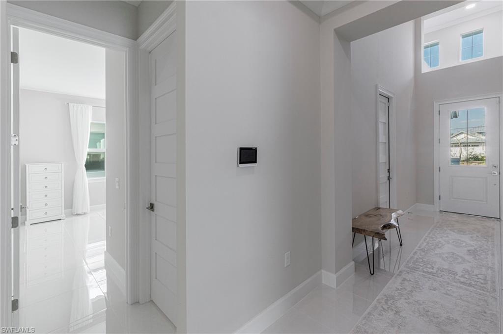 8982 Gustavia Court Naples, FL 34113 - Photo 18 of 44 a view of a hallway with workspace