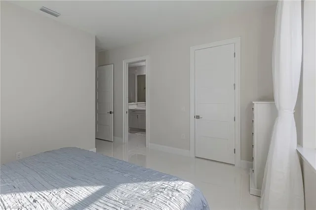 a bedroom with a bed and hallway