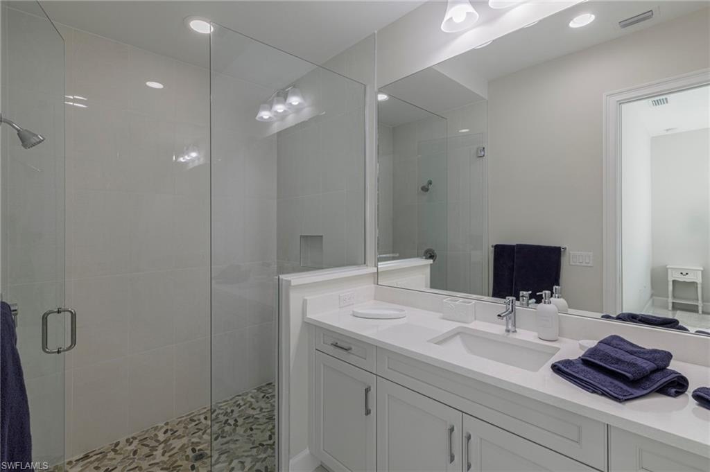 8982 Gustavia Court Naples, FL 34113 - Photo 21 of 44 a bathroom with a sink and a mirror