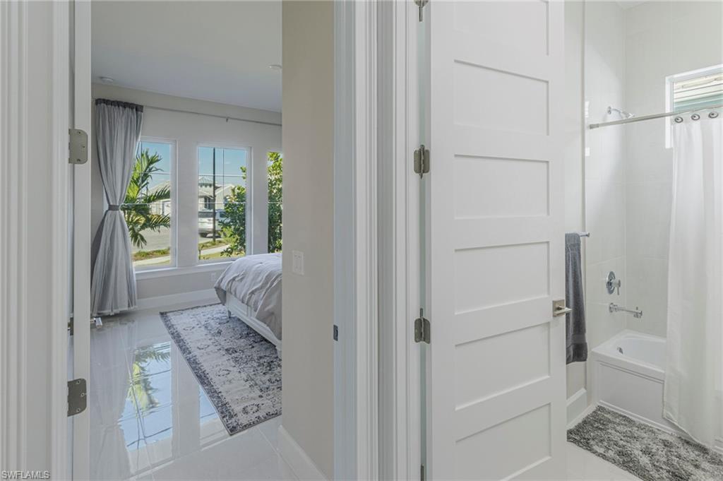 8982 Gustavia Court Naples, FL 34113 - Photo 22 of 44 a bathroom with a bathtub and shower