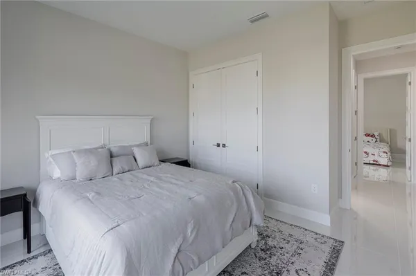 a bedroom with a bed and a rug
