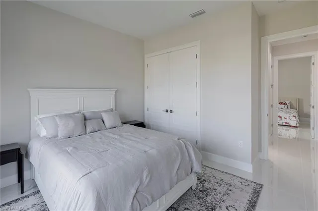 a bedroom with a bed and a rug