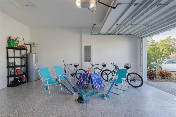 a view of swimming pool with a yard and palm trees