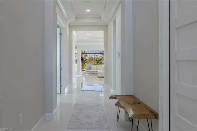 a view of a hallway and filled with furniture