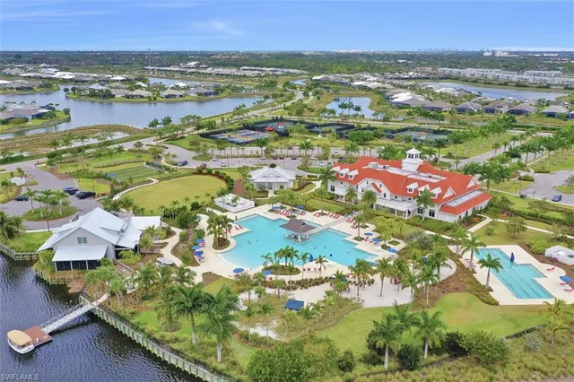 an aerial view of residential houses with outdoor space and swimming pool