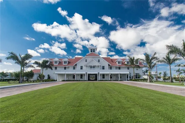 a view of swimming pool in front of house with yard and green space