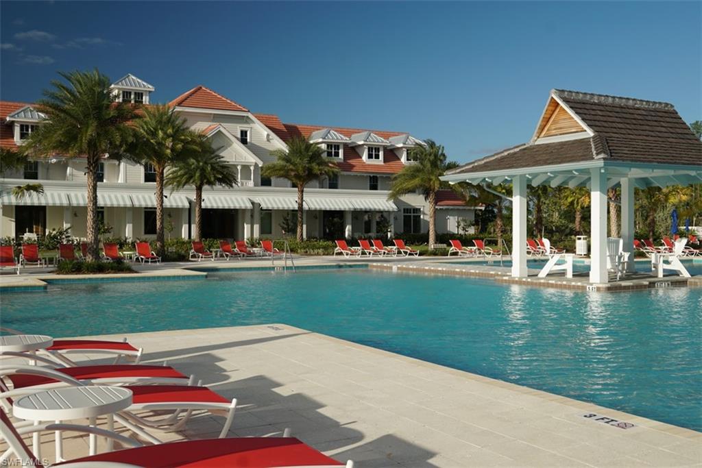 8982 Gustavia Court Naples, FL 34113 - Photo 36 of 44 a front view of a building with garden