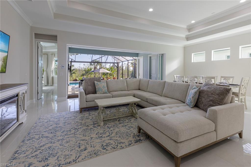 8982 Gustavia Court Naples, FL 34113 - Photo 4 of 44 a living room with furniture and a fireplace